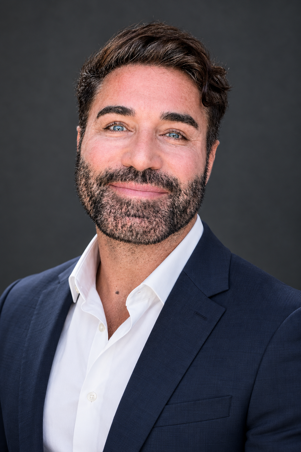 AI-created studio portrait of Bryan Blake in a navy suit and white shirt